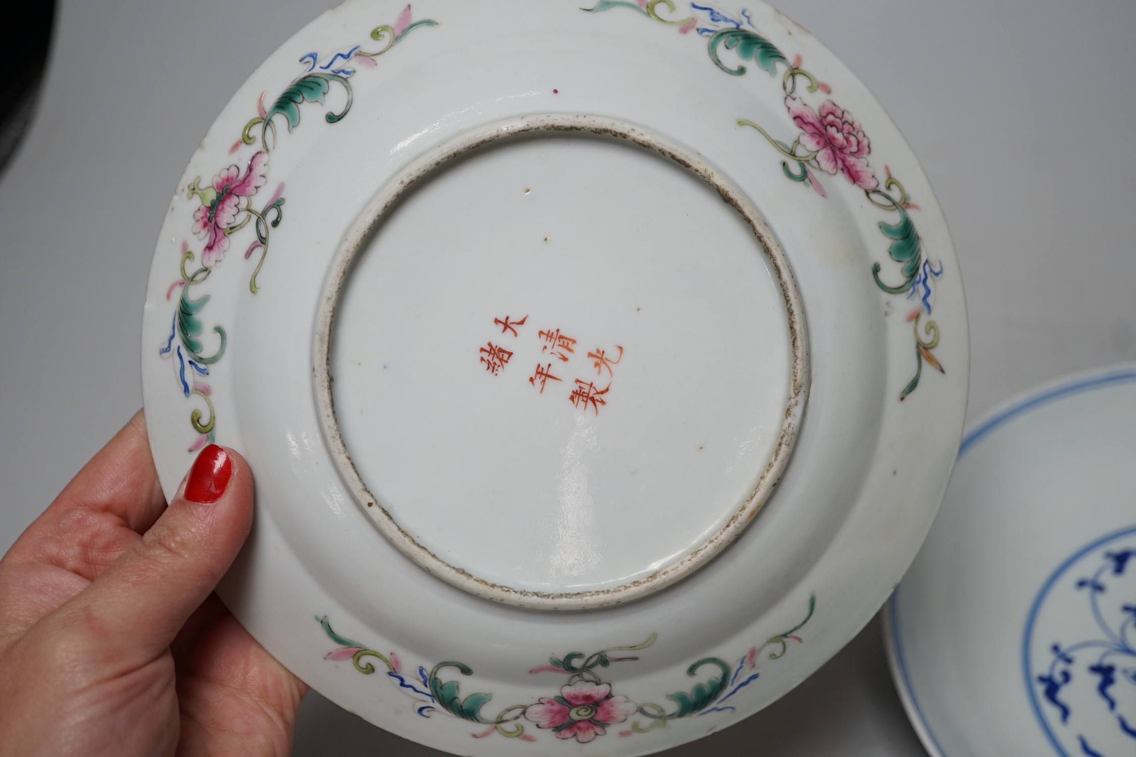 A Chinese blue and white dish and a similar enamelled dish, largest 20cm